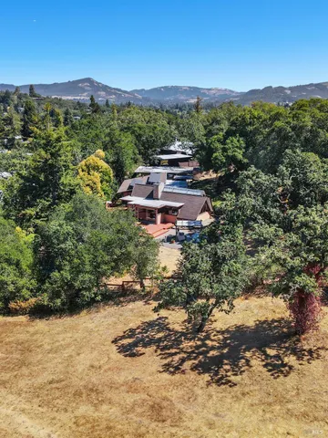 a aerial view of a house with a yard and lake view