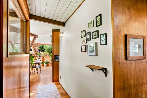 a view of a hallway with a dining area