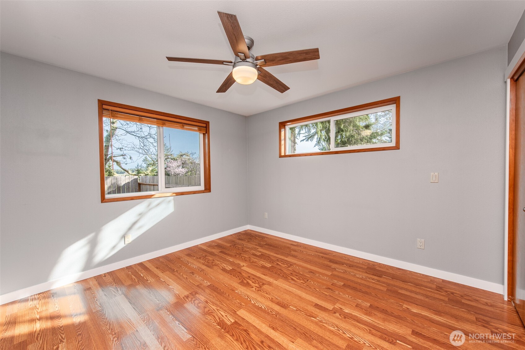 151 Nicole Place Sequim, WA 98382 - Photo 27 of 40 a view of an empty room with wooden floor and a ceiling fan