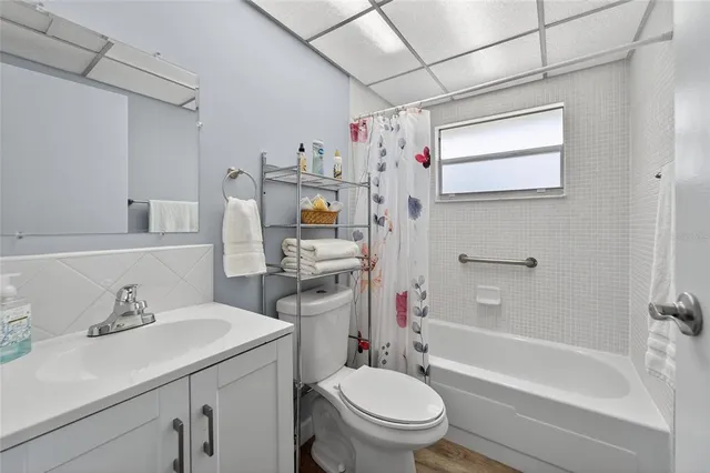 a bathroom with a sink toilet tub and shower