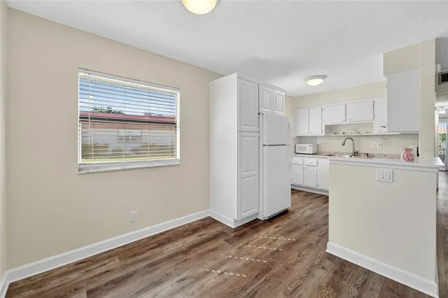 a kitchen with stainless steel appliances granite countertop a refrigerator sink and cabinets