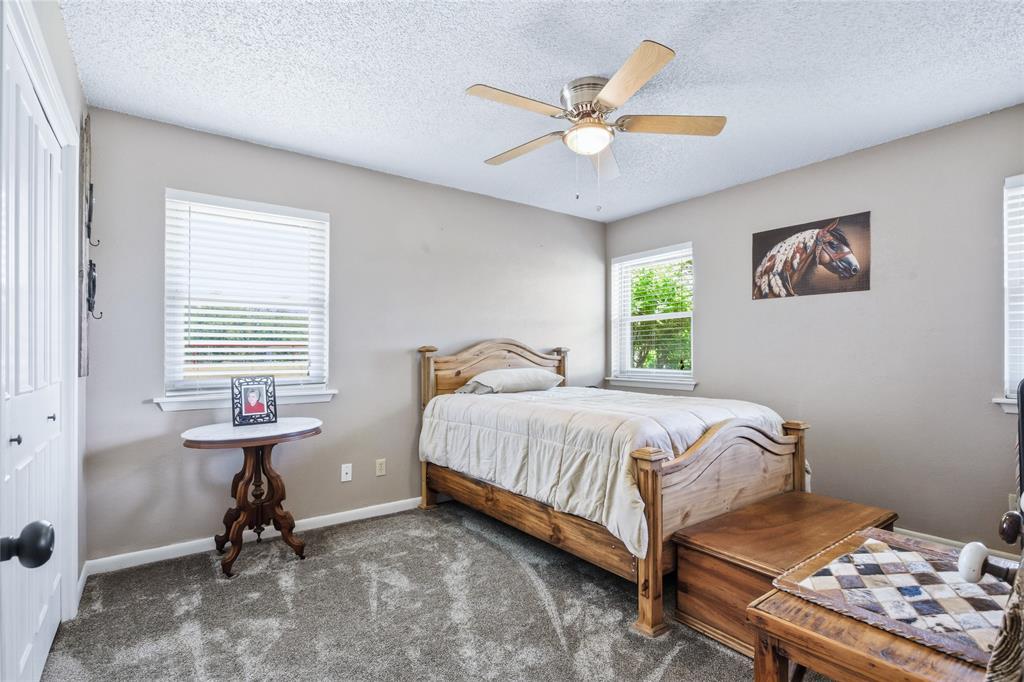 235 Magnus Road Denison, TX 75021 - Photo 20 of 35 a bedroom with a bed and a window