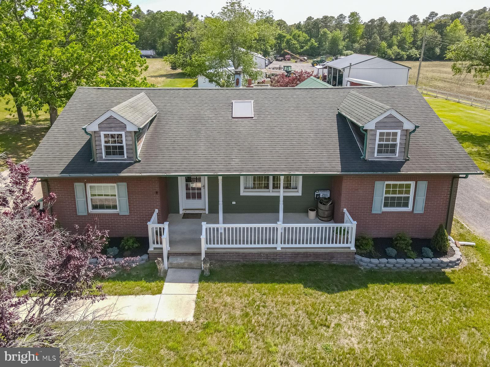 a aerial view of a house with swimming pool next to a yard