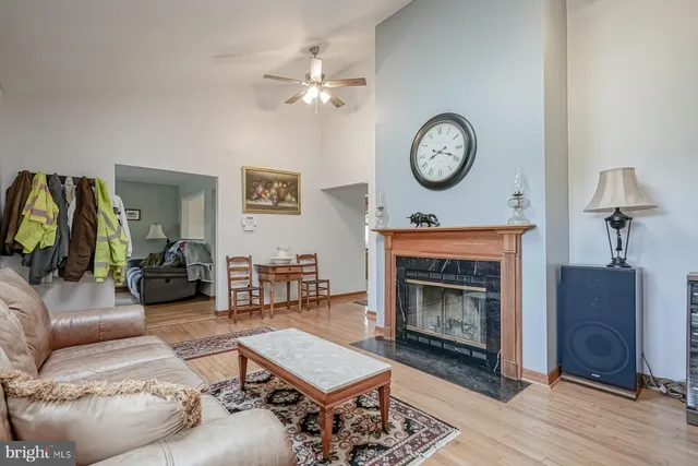 a kitchen with stainless steel appliances granite countertop a kitchen island a stove a table and chairs in it