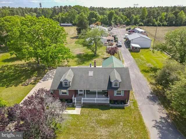 an aerial view of a house with swimming pool and ocean view