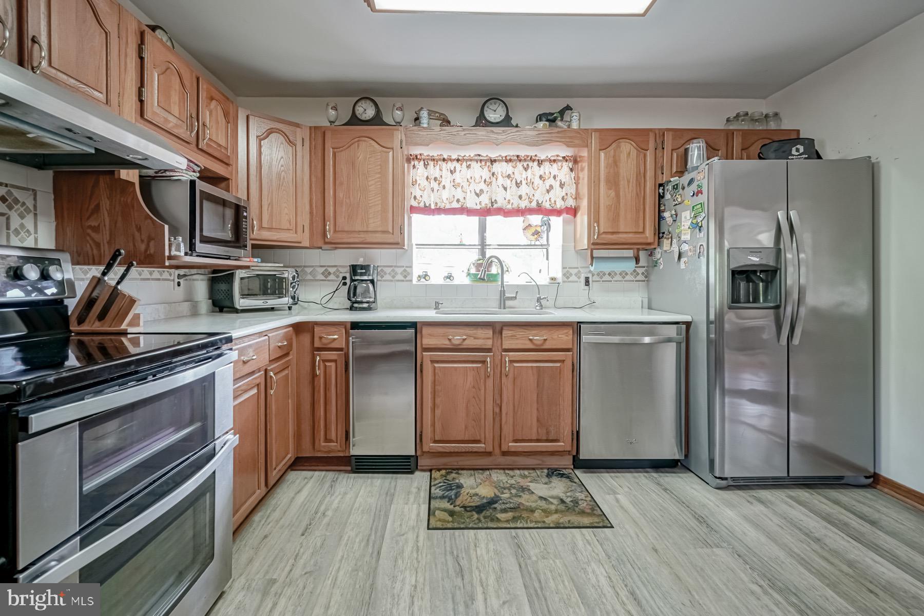 329 Lakedale Road Berlin, NJ 08009 - Photo 24 of 63 a kitchen with a sink stove and refrigerator