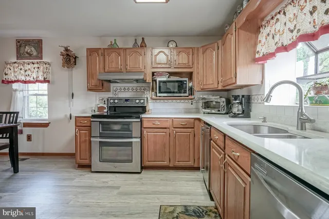 a view of empty room with wooden floor and cabinet