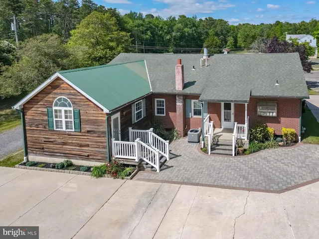 a backyard of a house with yard and large tree