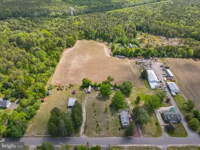 an aerial view of a house with a yard and trees