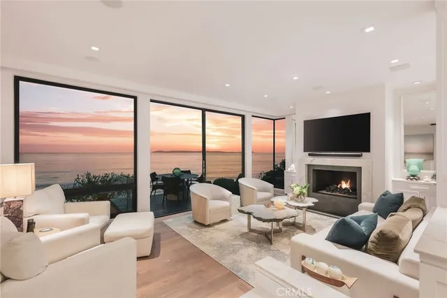a living room with fireplace furniture and a large window