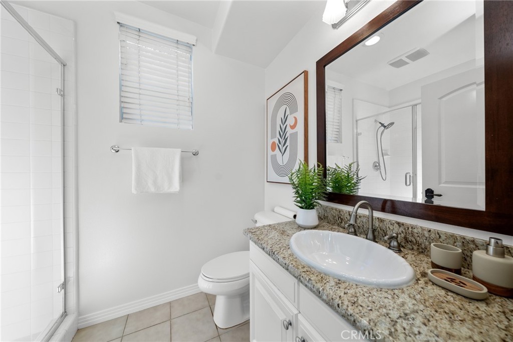 26 Twin Gables Irvine, CA 92620 - Photo 12 of 36 a bathroom with a granite countertop sink and a mirror
