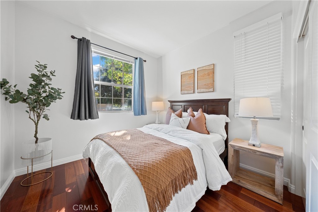 26 Twin Gables Irvine, CA 92620 - Photo 13 of 36 a bedroom with a bed and a potted plant