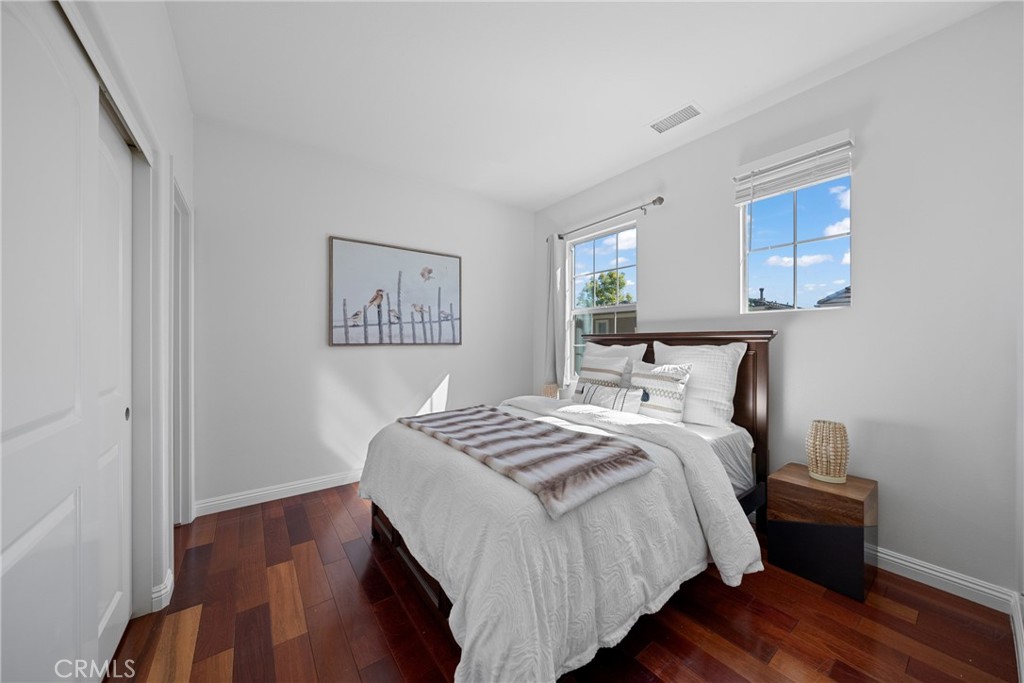 26 Twin Gables Irvine, CA 92620 - Photo 16 of 36 a bedroom with bed and wooden floor