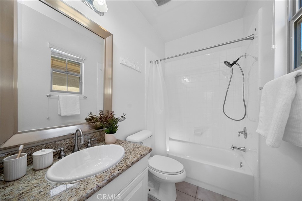 26 Twin Gables Irvine, CA 92620 - Photo 17 of 36 a bathroom with a granite countertop sink toilet a mirror and shower