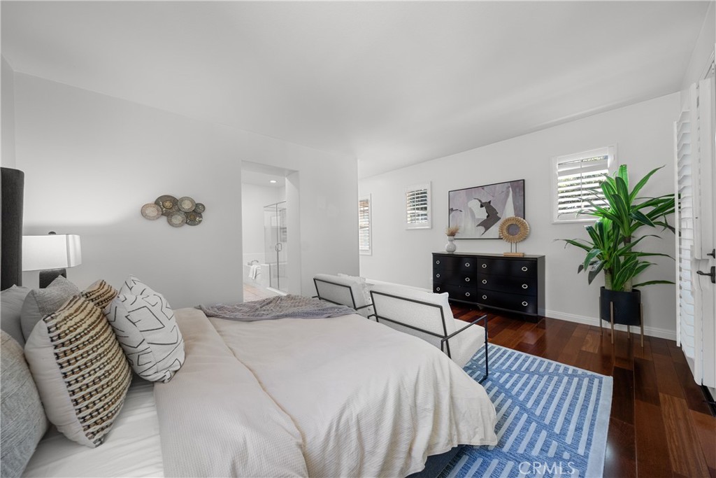 26 Twin Gables Irvine, CA 92620 - Photo 19 of 36 a bedroom with a bed and a potted plant on dresser