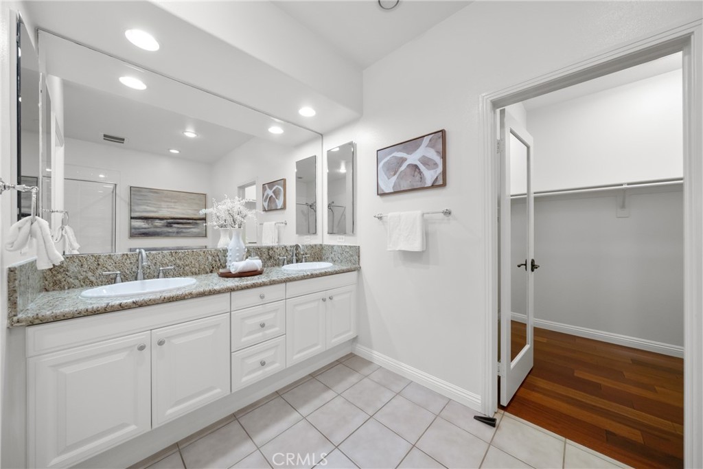 26 Twin Gables Irvine, CA 92620 - Photo 21 of 36 a spacious bathroom with a granite countertop sink and a mirror