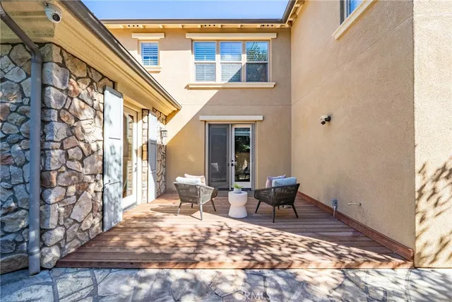a view of a patio with couple of chairs and a couch