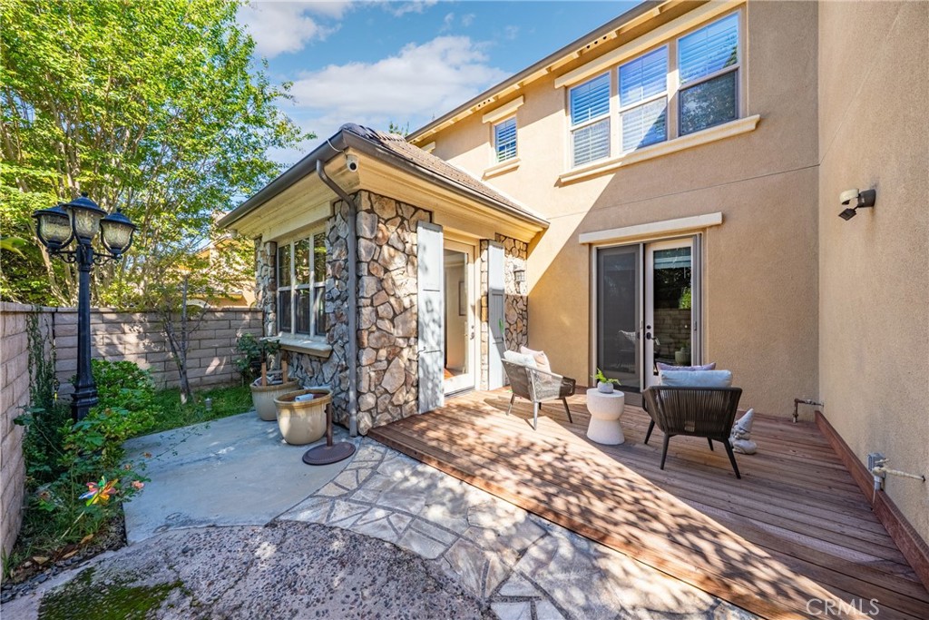 26 Twin Gables Irvine, CA 92620 - Photo 27 of 36 a view of a patio with couple of chairs and a fountain