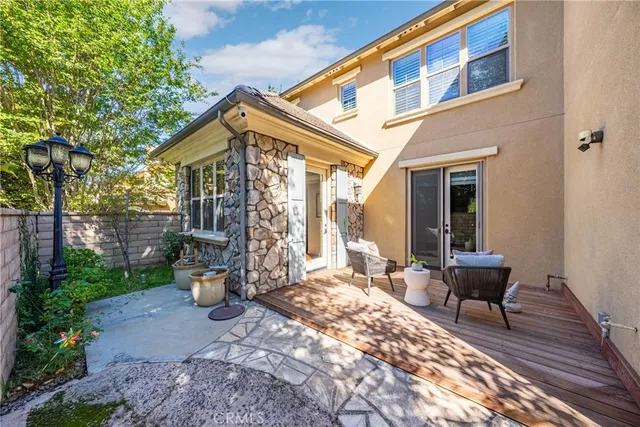 a view of a patio with couple of chairs and a fountain