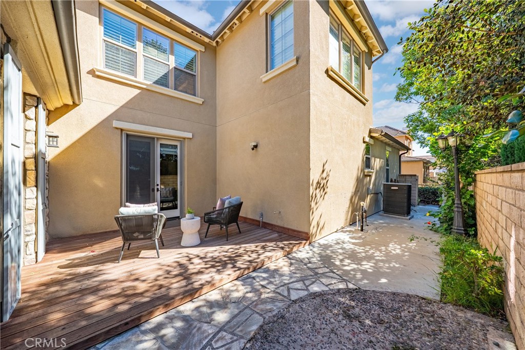 26 Twin Gables Irvine, CA 92620 - Photo 28 of 36 a view of a patio with a table and chairs and floor to ceiling window