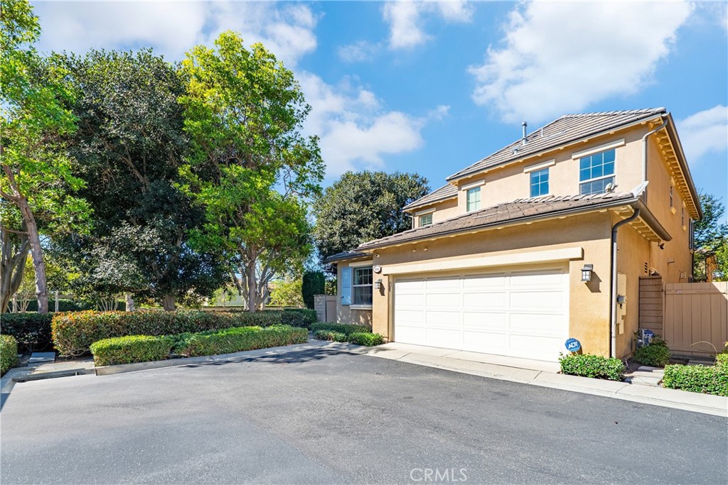 26 Twin Gables Irvine, CA 92620 - Photo 29 of 36 a front view of a house with a yard and garage