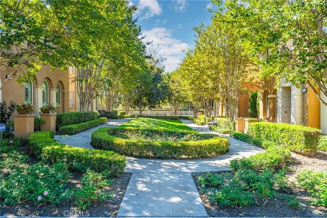 a view of a garden with large trees