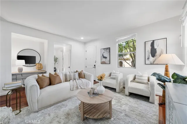 a living room with furniture and a painting on the wall