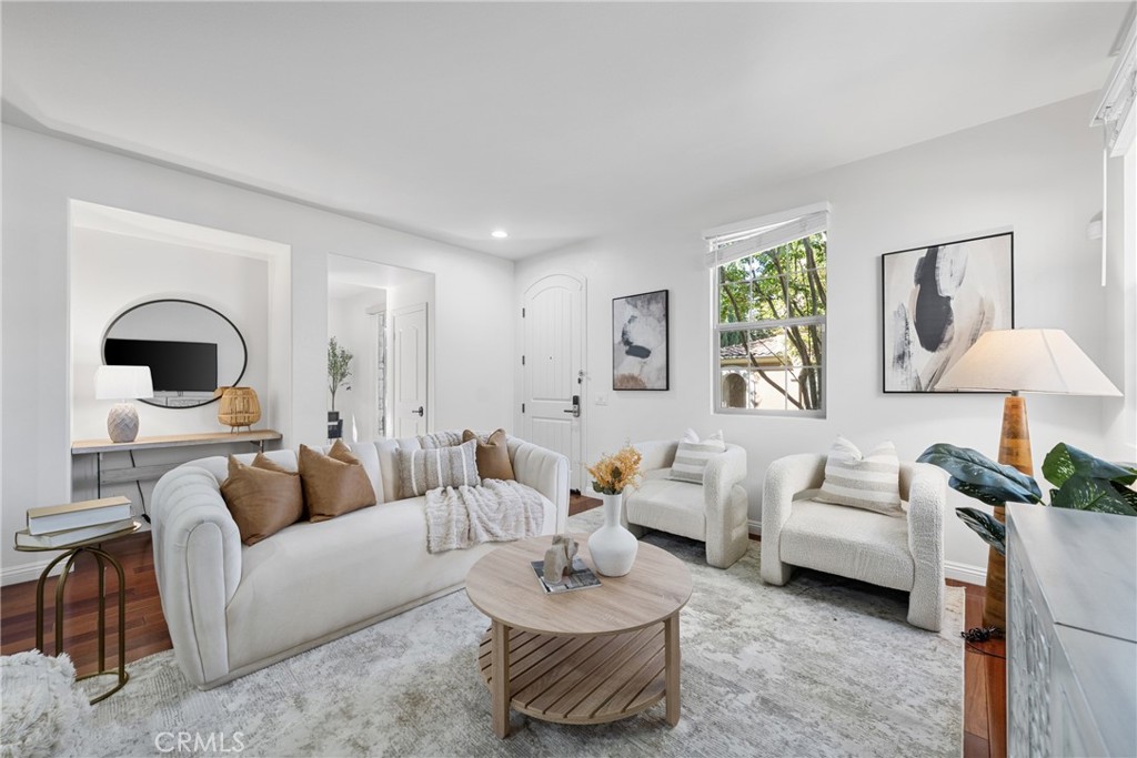 26 Twin Gables Irvine, CA 92620 - Photo 6 of 36 a living room with furniture and a painting on the wall