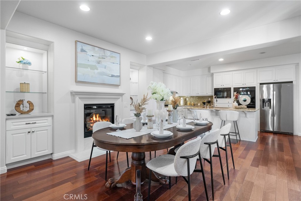 26 Twin Gables Irvine, CA 92620 - Photo 7 of 36 a view of a dining room with furniture and wooden floor