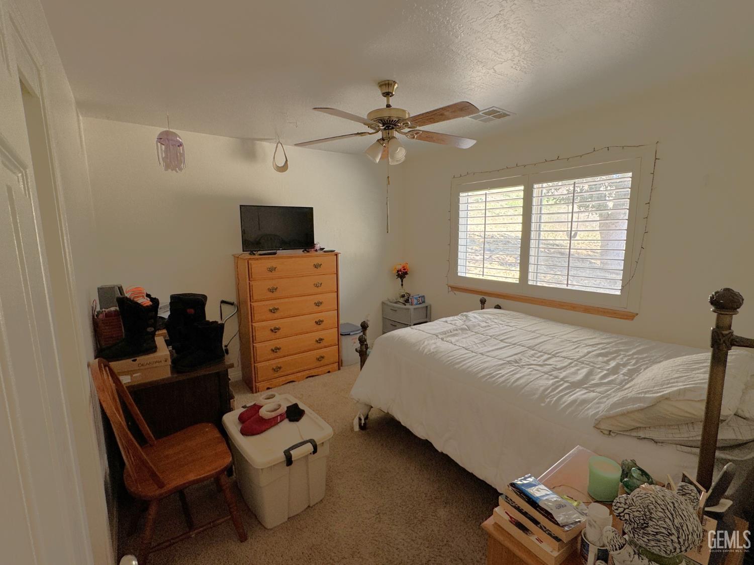 Undisclosed Address Tehachapi, CA 93561 - Photo 11 of 16 a bedroom with furniture and a flat screen tv