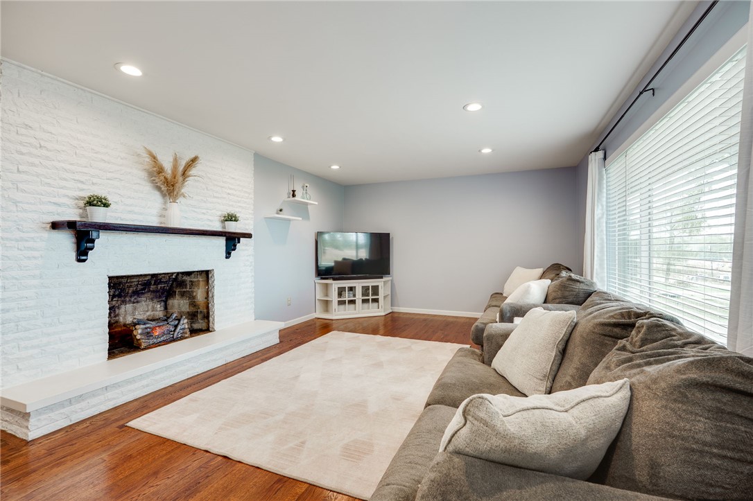 6950 Red Lion 5 Points Road Springboro, OH 45066 - Photo 10 of 78 This inviting living room showcases a beautifully crafted fireplace and warm hardwood flooring.