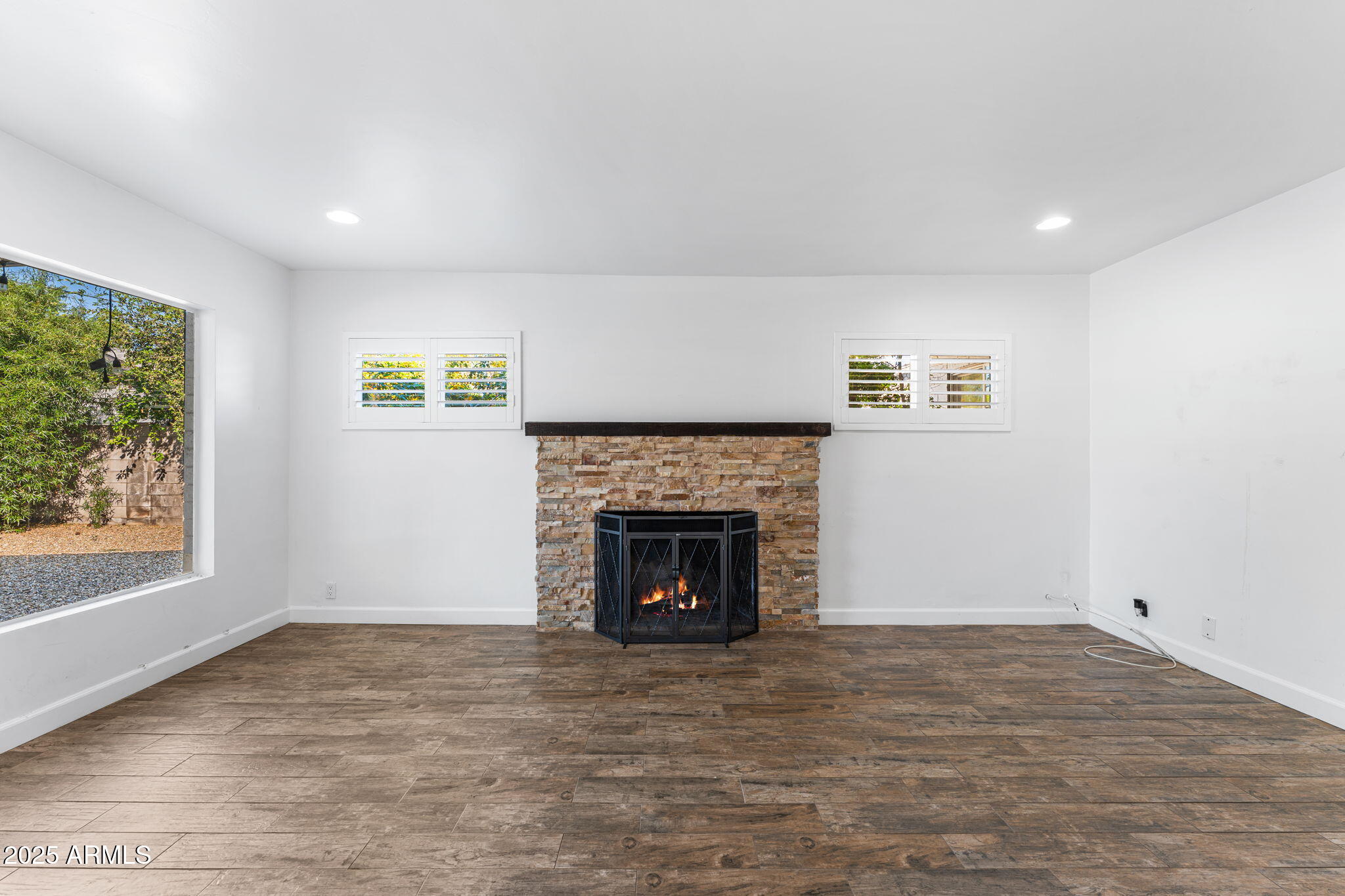 1334 West Sells Drive Phoenix, AZ 85013 - Photo 11 of 32 a view of an empty room with a fireplace and a window