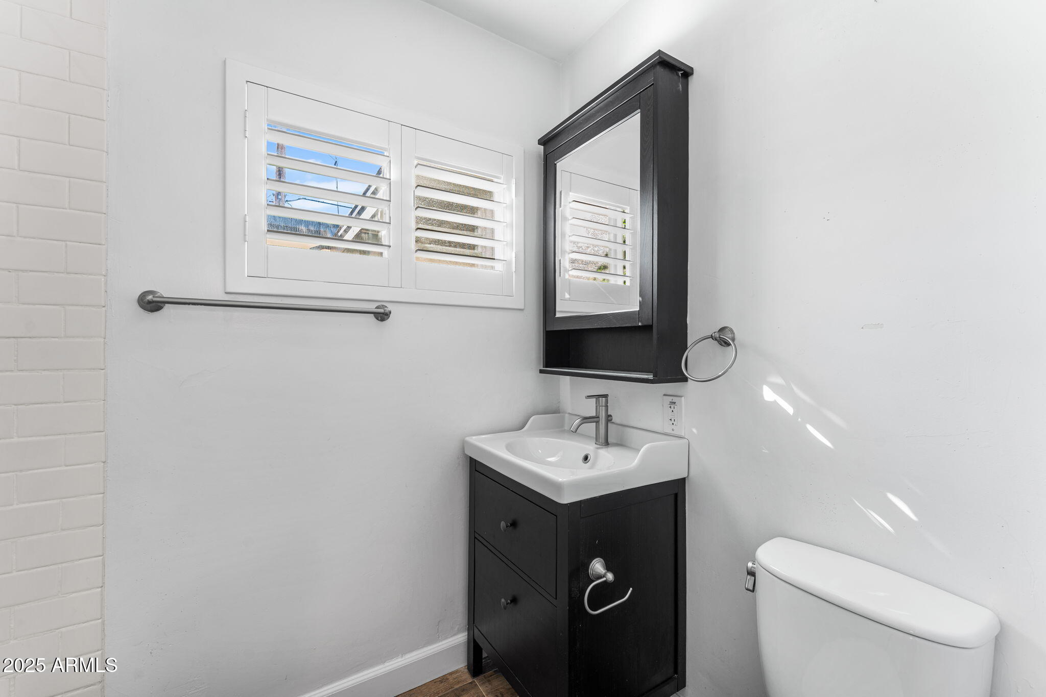 1334 West Sells Drive Phoenix, AZ 85013 - Photo 15 of 32 a bathroom with a toilet sink and mirror
