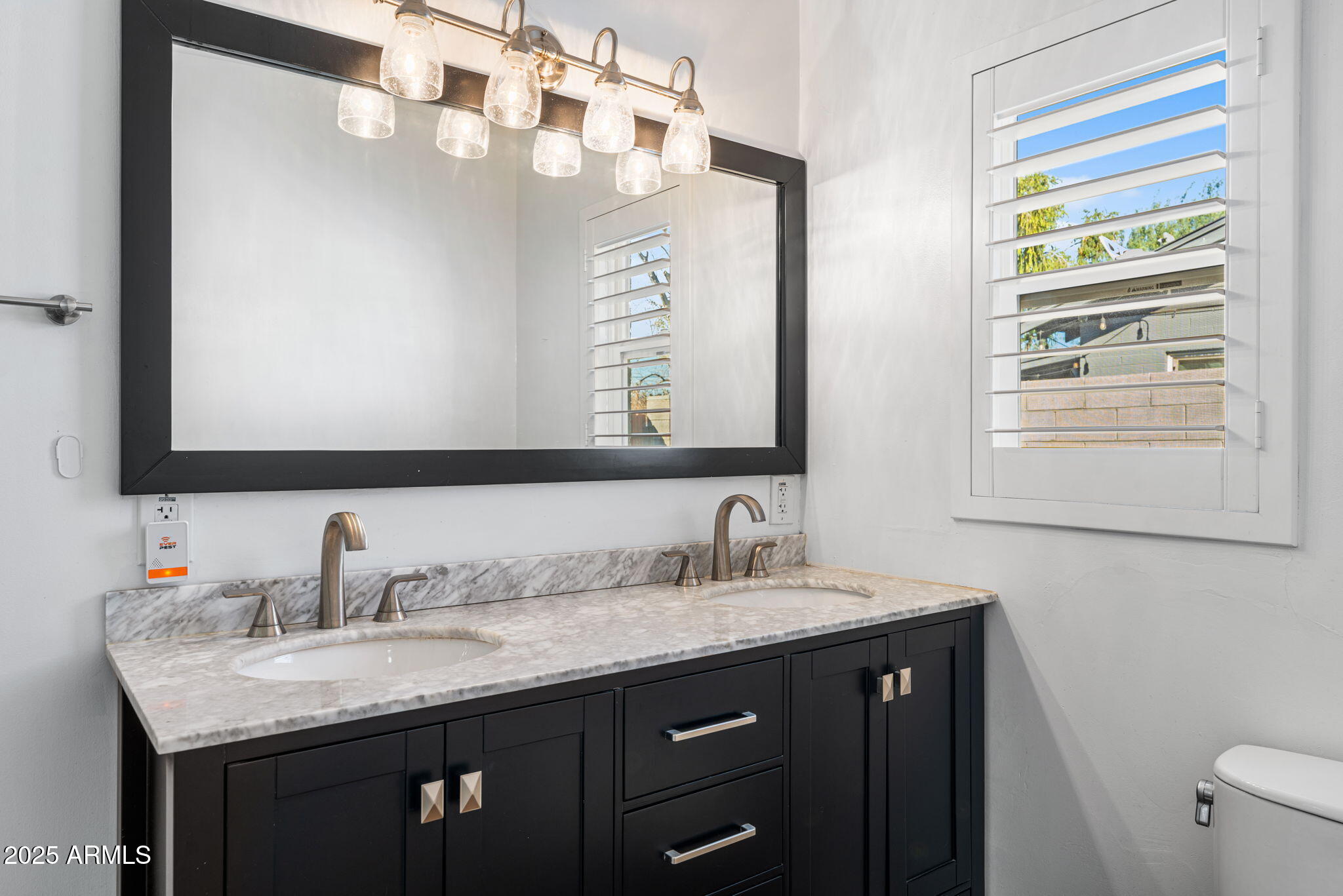1334 West Sells Drive Phoenix, AZ 85013 - Photo 18 of 32 a bathroom with a granite countertop sink and a mirror