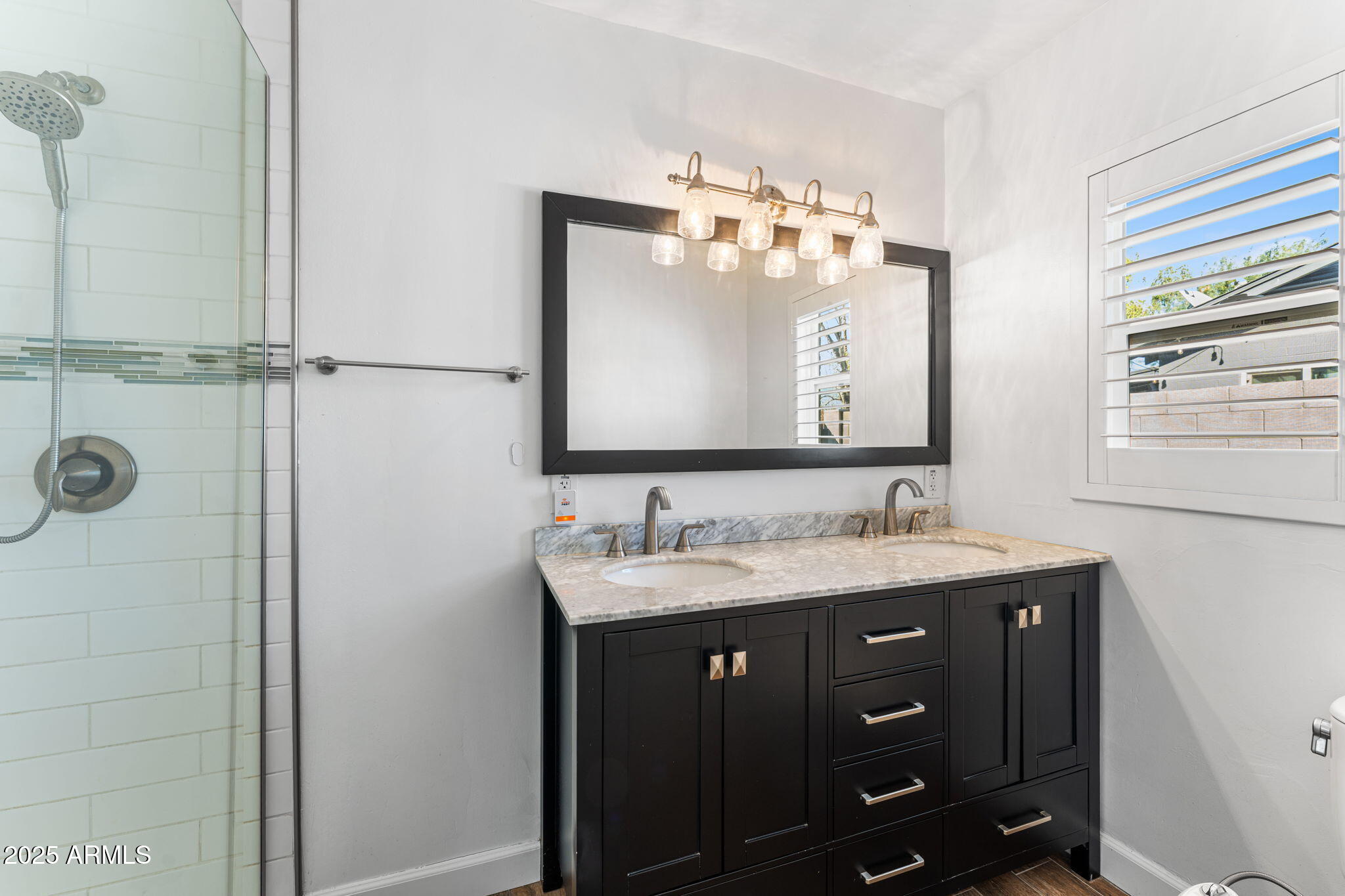 1334 West Sells Drive Phoenix, AZ 85013 - Photo 20 of 32 a bathroom with a double vanity sink and a mirror