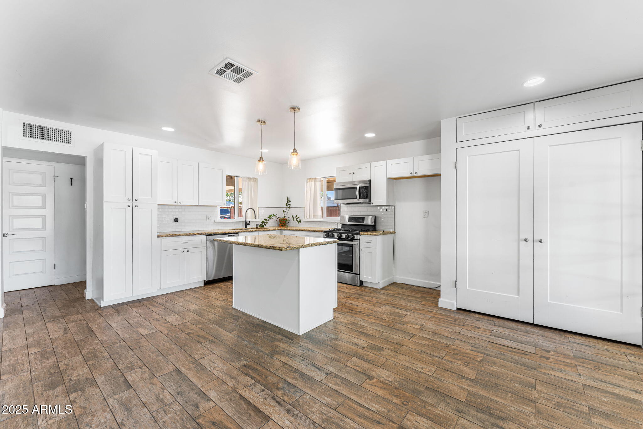 1334 West Sells Drive Phoenix, AZ 85013 - Photo 8 of 32 a kitchen with white cabinets and white appliances