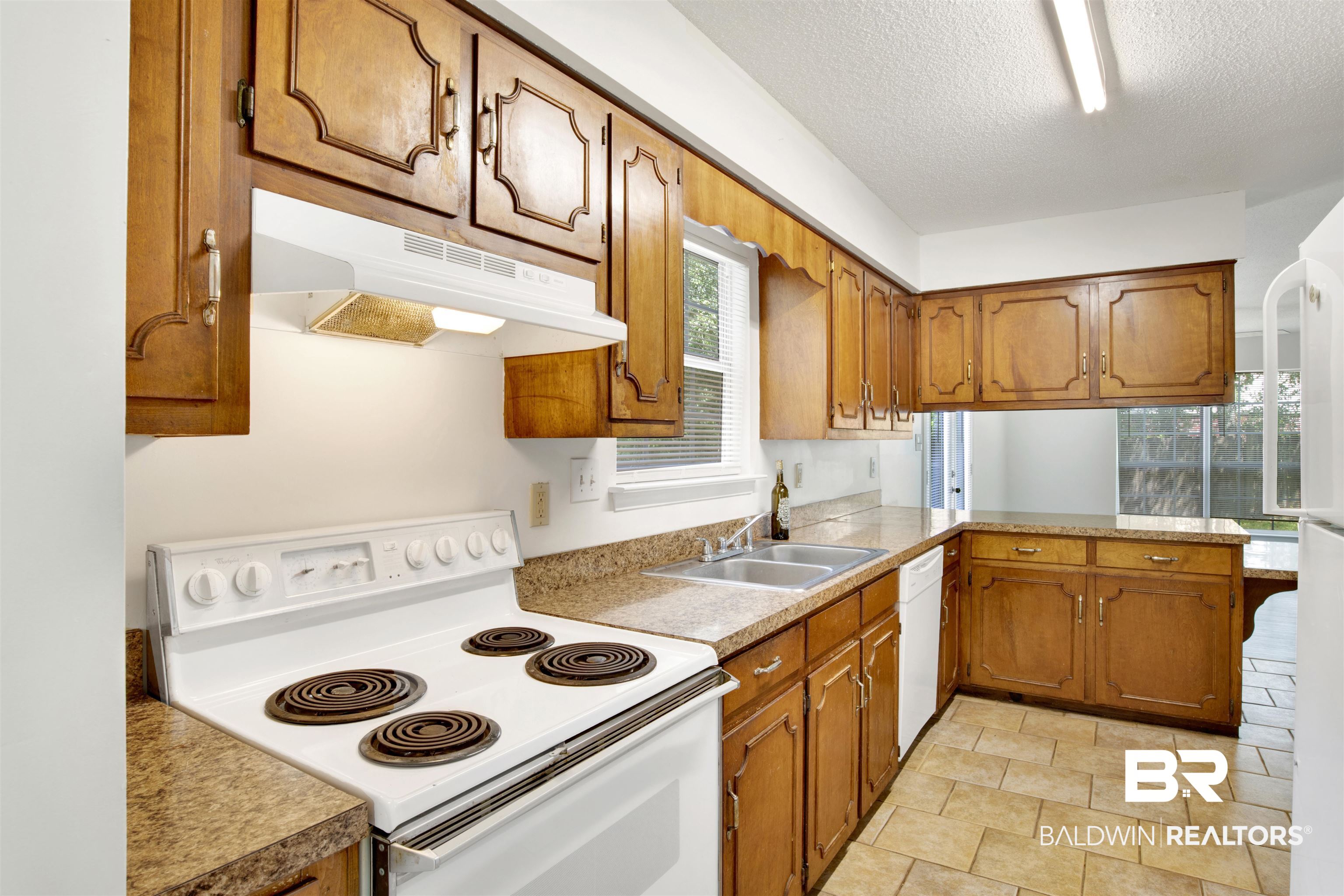 5480 Country Club Boulevard Theodore, AL 36582 - Photo 10 of 36 Kitchen featuring white appliances, a textured ceiling, and sink