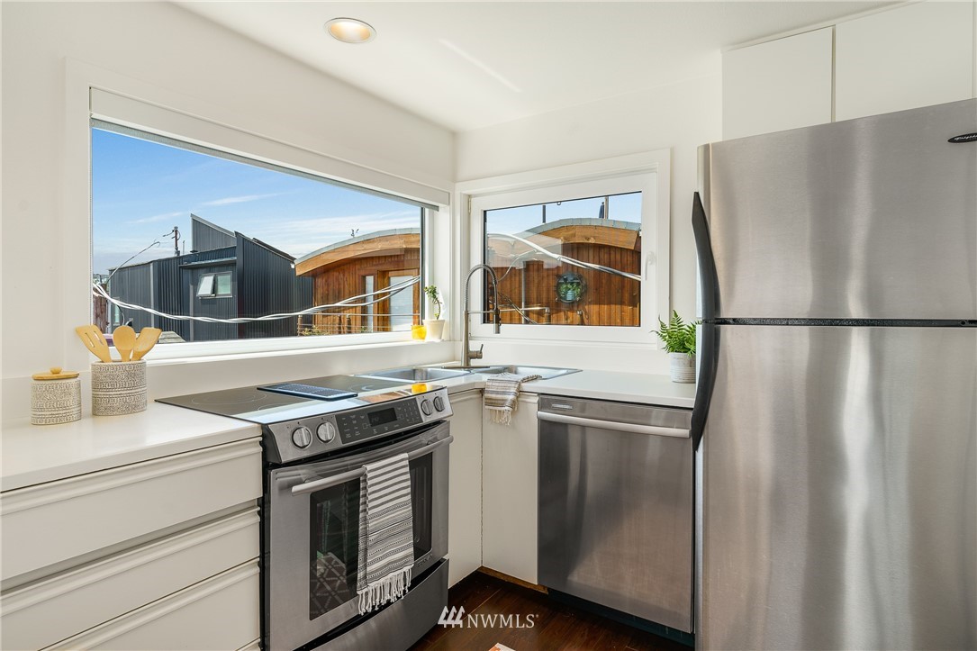2031 Fairview Avenue East, Unit E Seattle, WA 98102 - Photo 11 of 32 a kitchen with stainless steel appliances granite countertop a refrigerator and a stove