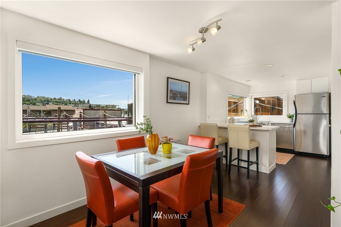 2031 Fairview Avenue East, Unit E Seattle, WA 98102 - Photo 9 of 32 a view of a dining room with furniture window and wooden floor