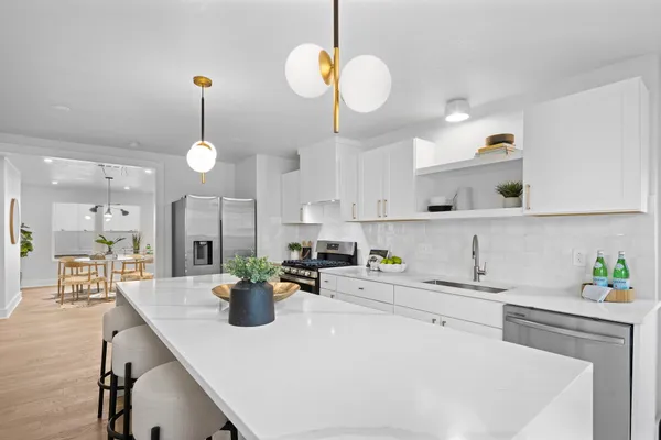 a kitchen with a sink a counter space and cabinets