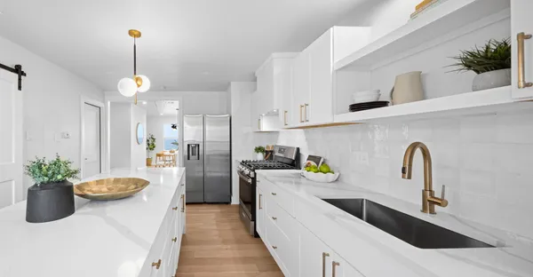 a kitchen with sink refrigerator and stove