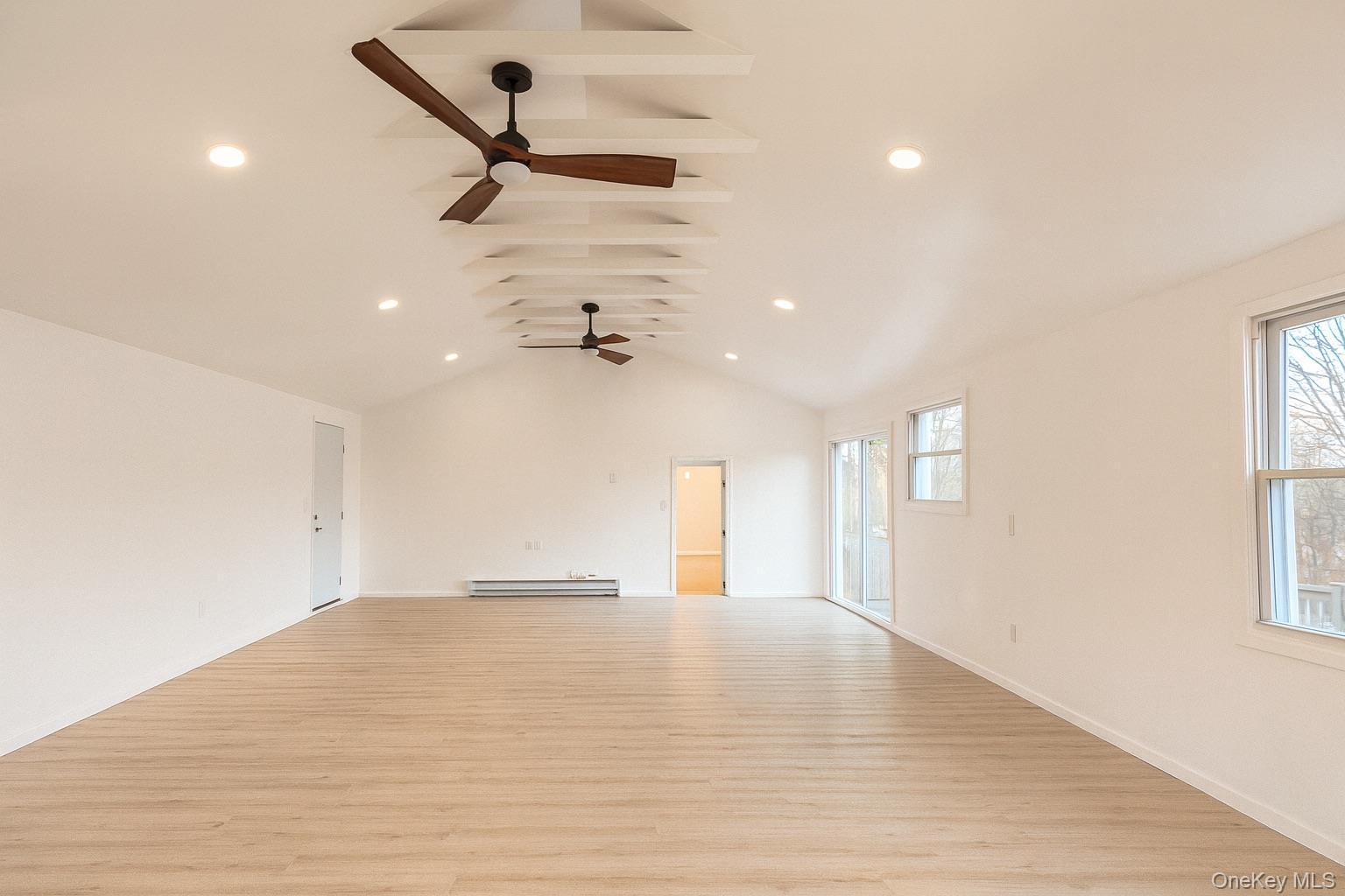 88 Cold Spring Road Liberty, NY 12754 - Photo 30 of 32 Unfurnished living room featuring vaulted ceiling, light wood-type flooring, recessed lighting, and a baseboard radiator