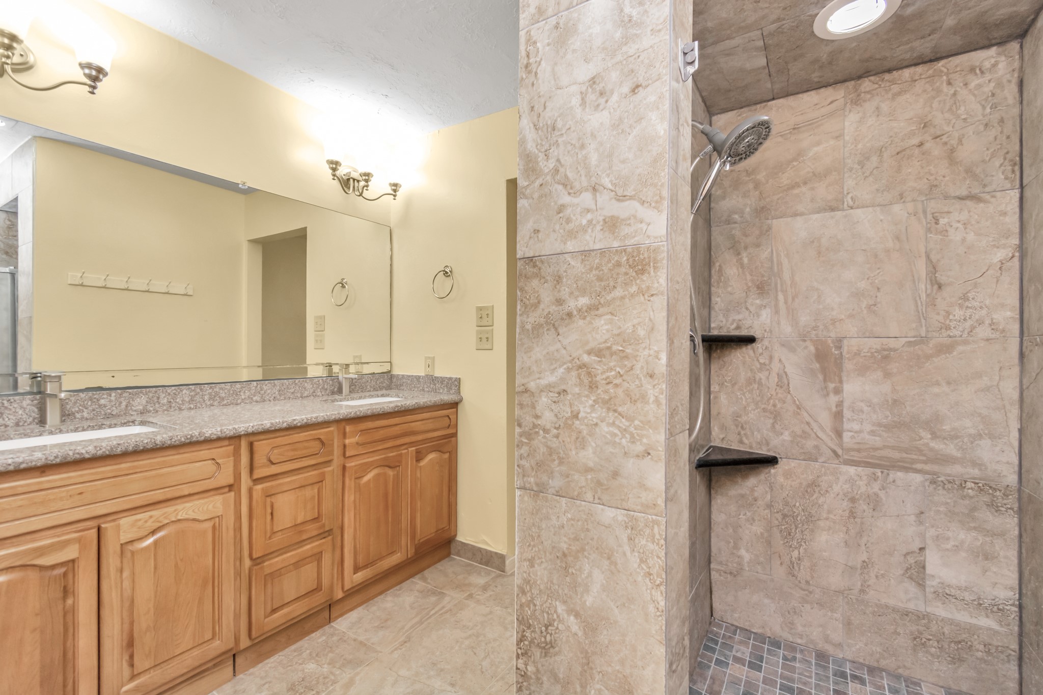 4702 Cashel Circle, Unit B Houston, TX 77069 - Photo 17 of 34 a bathroom with a granite countertop sink a mirror and a shower