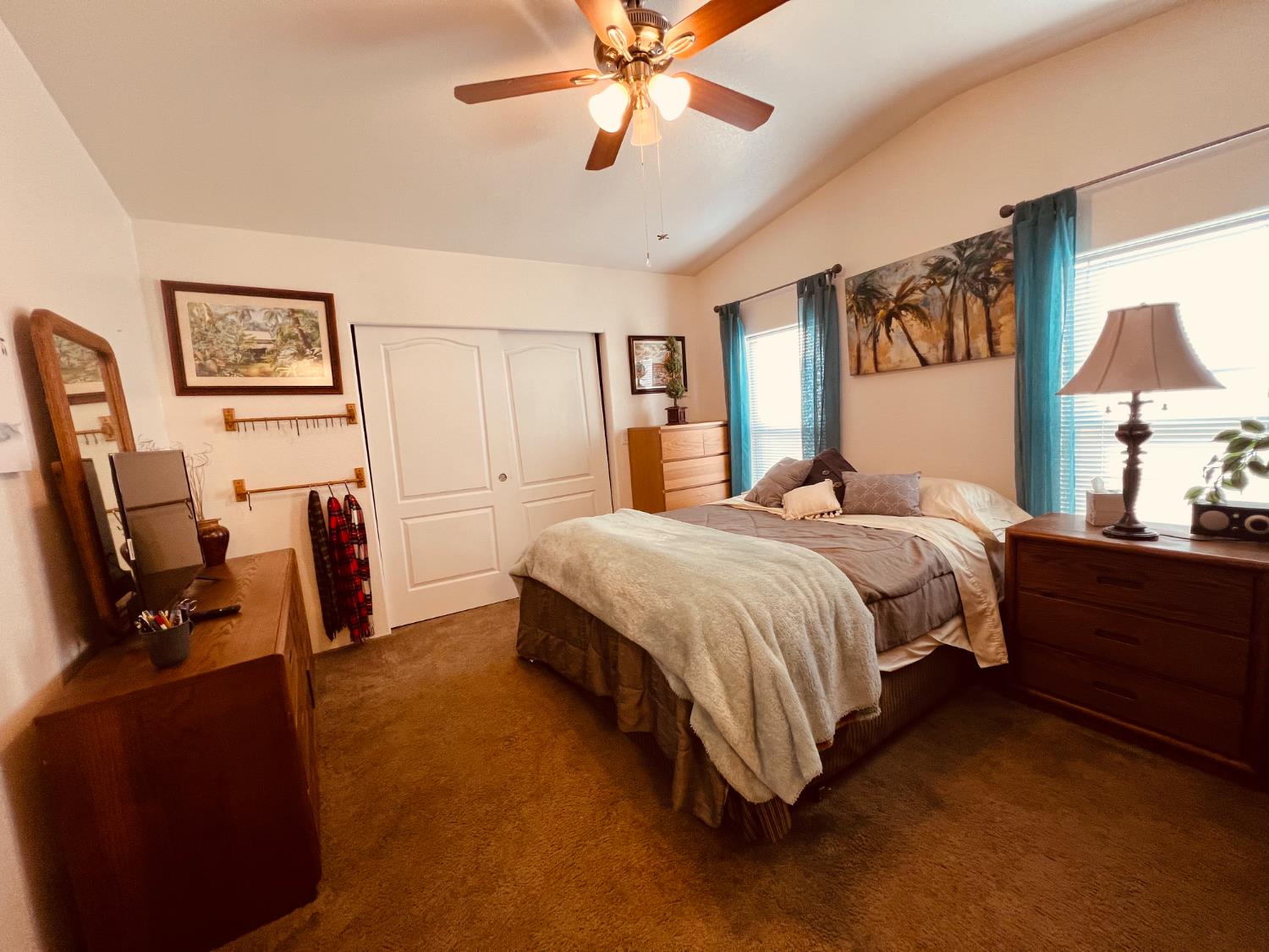 195 Schooner Lane Modesto, CA 95356 - Photo 13 of 24 a spacious bedroom with a bed a dresser and book shelfs