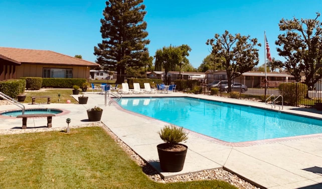 195 Schooner Lane Modesto, CA 95356 - Photo 22 of 24 a view of a swimming pool with a patio