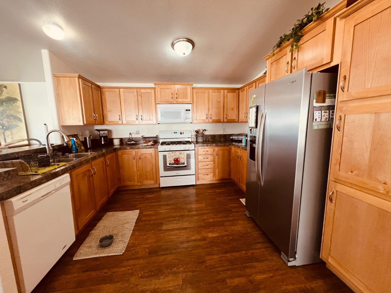 195 Schooner Lane Modesto, CA 95356 - Photo 6 of 24 a kitchen with stainless steel appliances granite countertop a refrigerator a sink dishwasher a stove top oven a refrigerator and cabinets