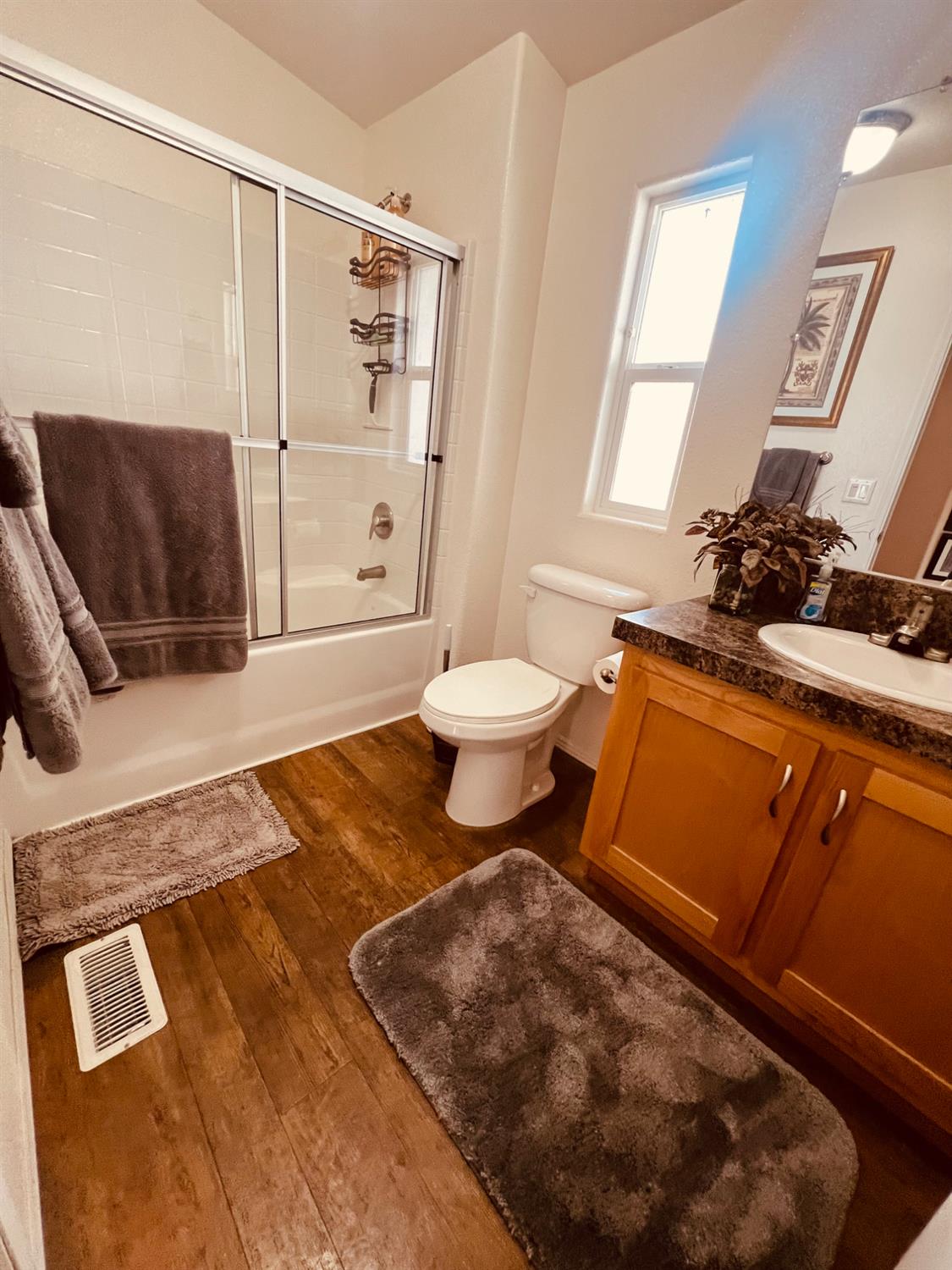 195 Schooner Lane Modesto, CA 95356 - Photo 10 of 24 a bathroom with a toilet sink and mirror