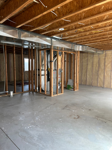 175 North 100th West Centerfield, UT 84622 - Photo 32 of 32 Unfinished basement space featuring exposed wood joists, galvanized ductwork, and structural framing. Furnace and water heater.