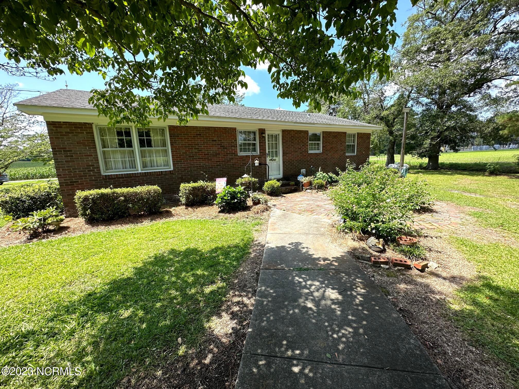 3832 Farmers Union Road Clarkton, NC 28433 - Photo 21 of 36 Walkway to Rear Detached Building