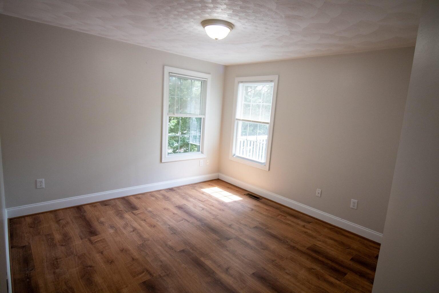 3727 Chaparral Drive Roanoke, VA 24018 - Photo 8 of 24 an empty room with wooden floor and windows